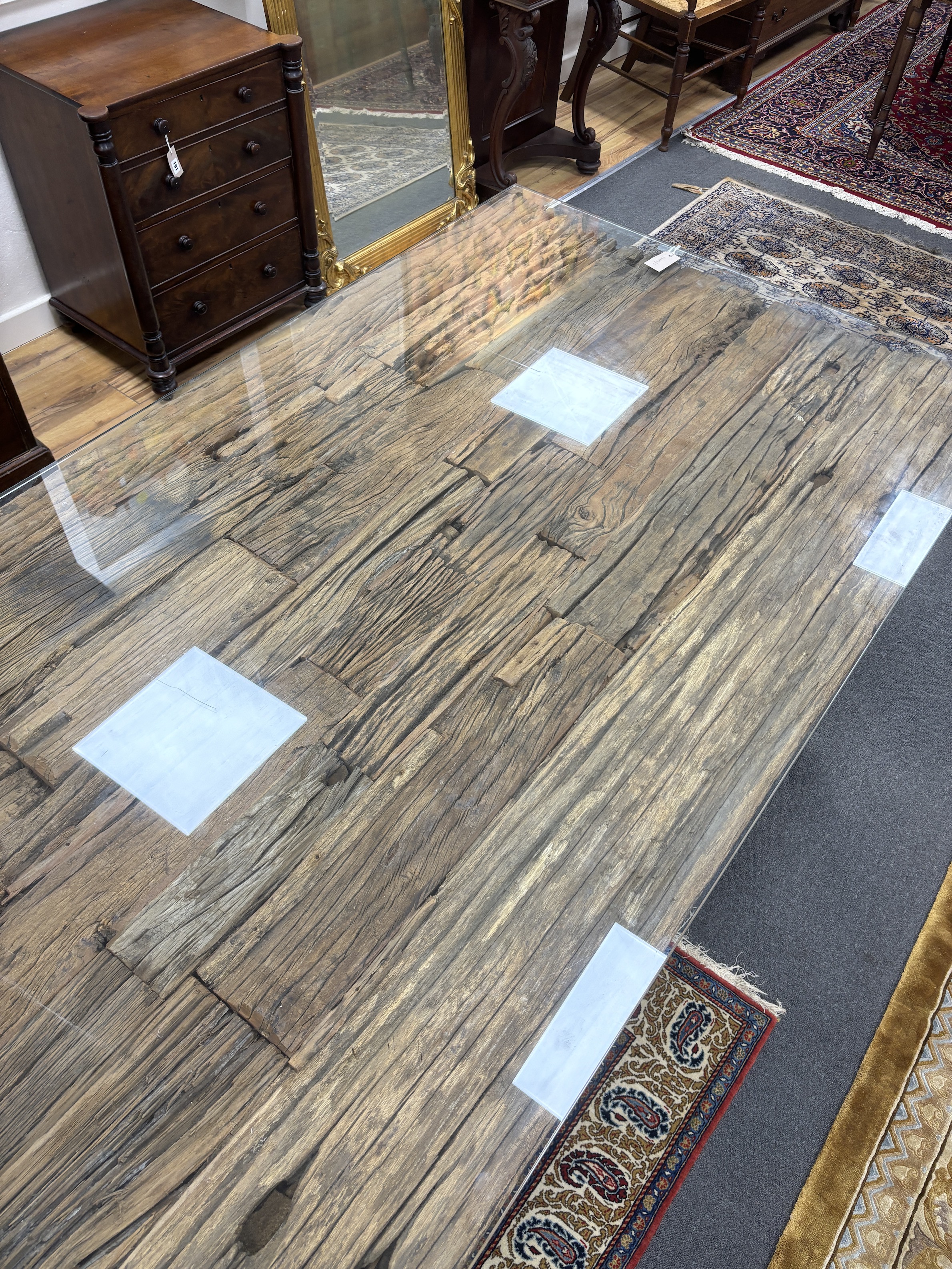 A rustic rectangular driftwood dining table, on a stainless steel base with plate glass top, length 240cm, width 100cm, height 77cm